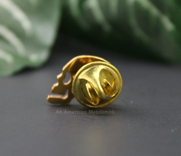 Rear view of a brass skull pin made by An American Metalsmith