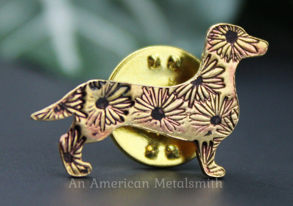 Brass dachshund pin with daisy stamps made by An American Metalsmith