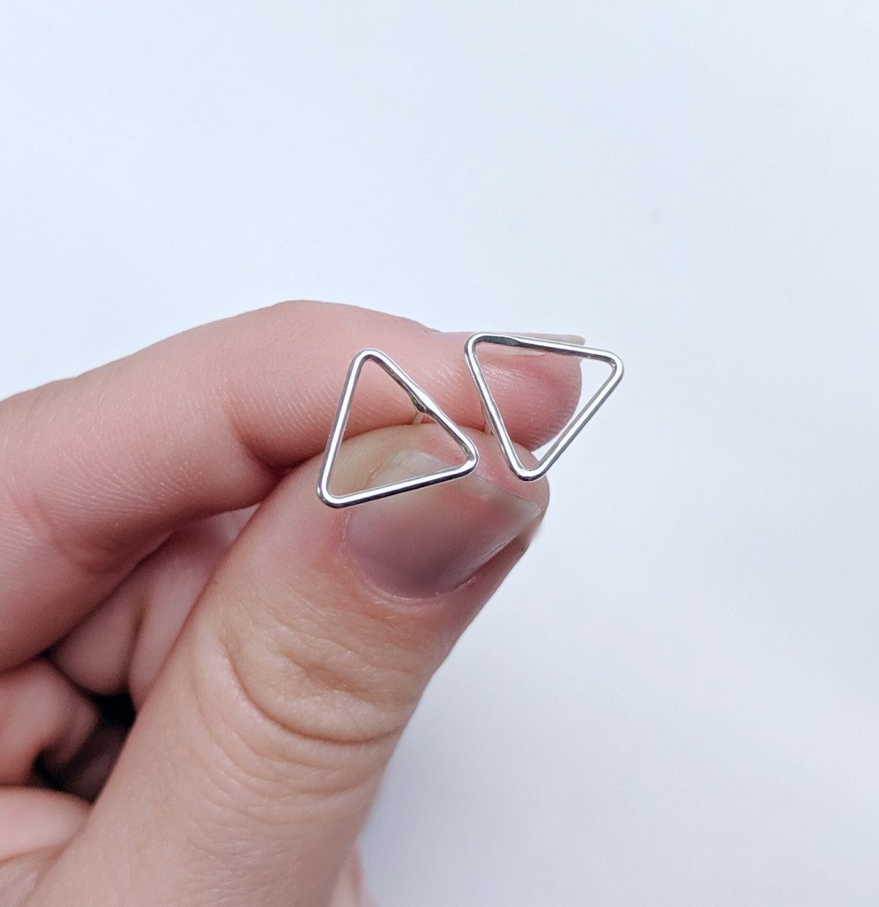 Triangular stud earrings made by An American Metalsmith