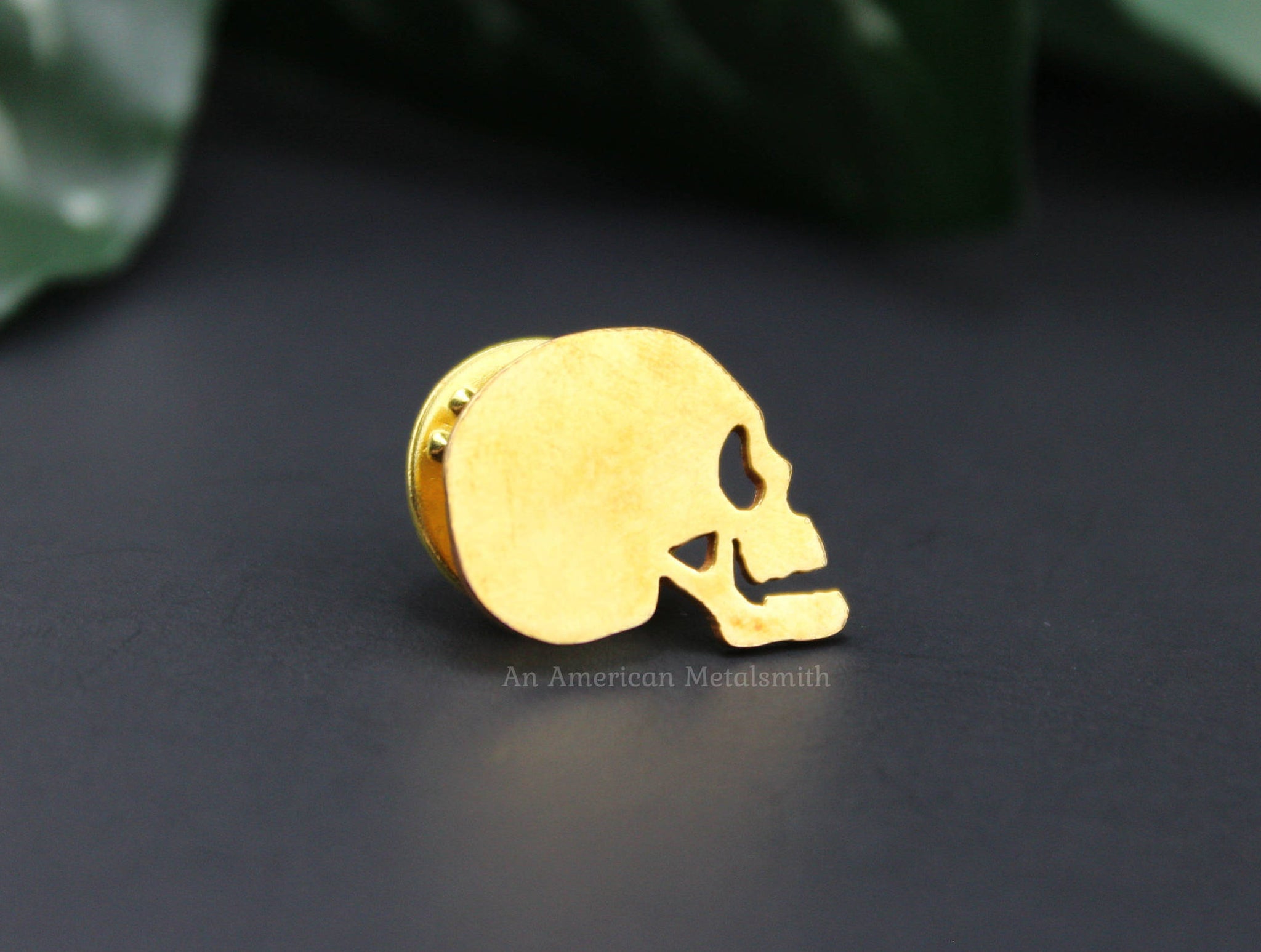 Brass skull pin made by An American Metalsmith